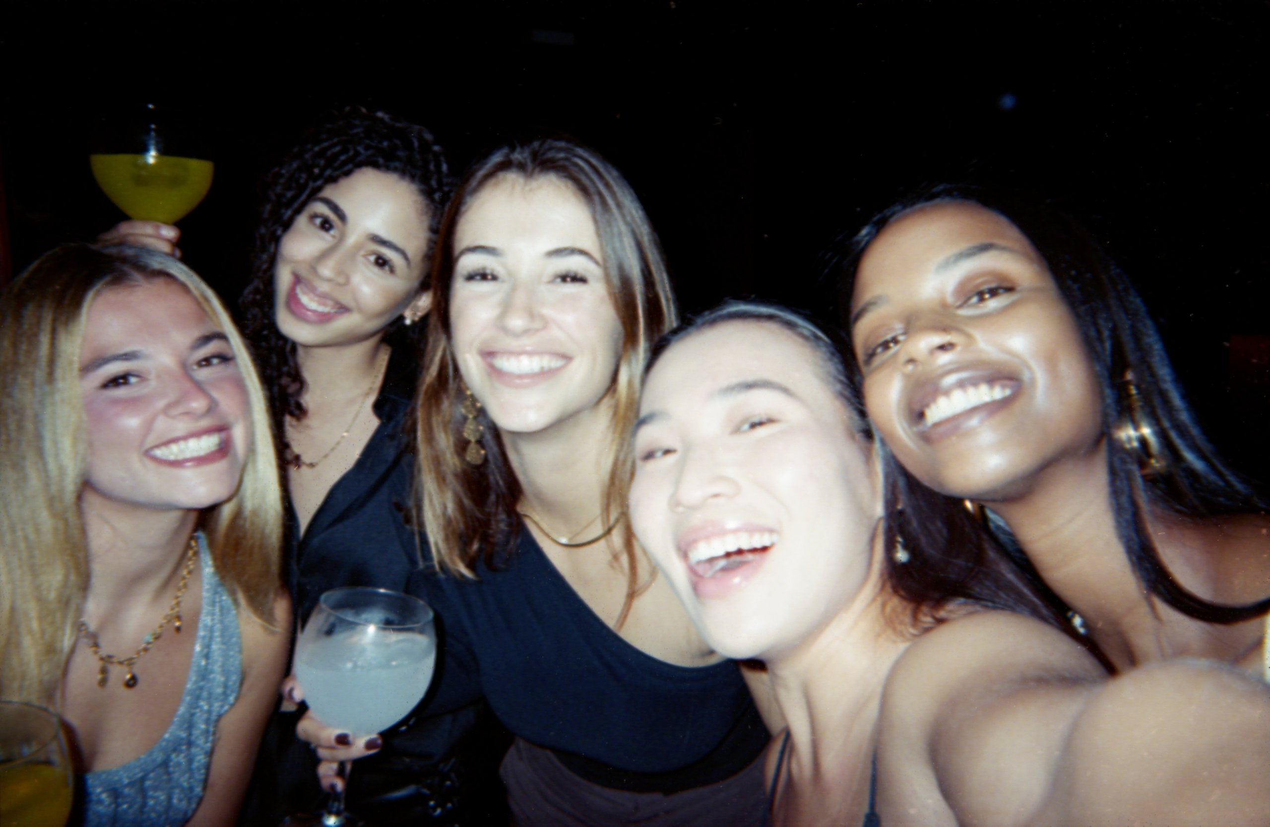 Group of happy friends posing together in a lively atmosphere