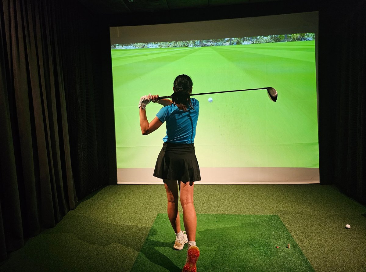 Professional female golfer on simulator