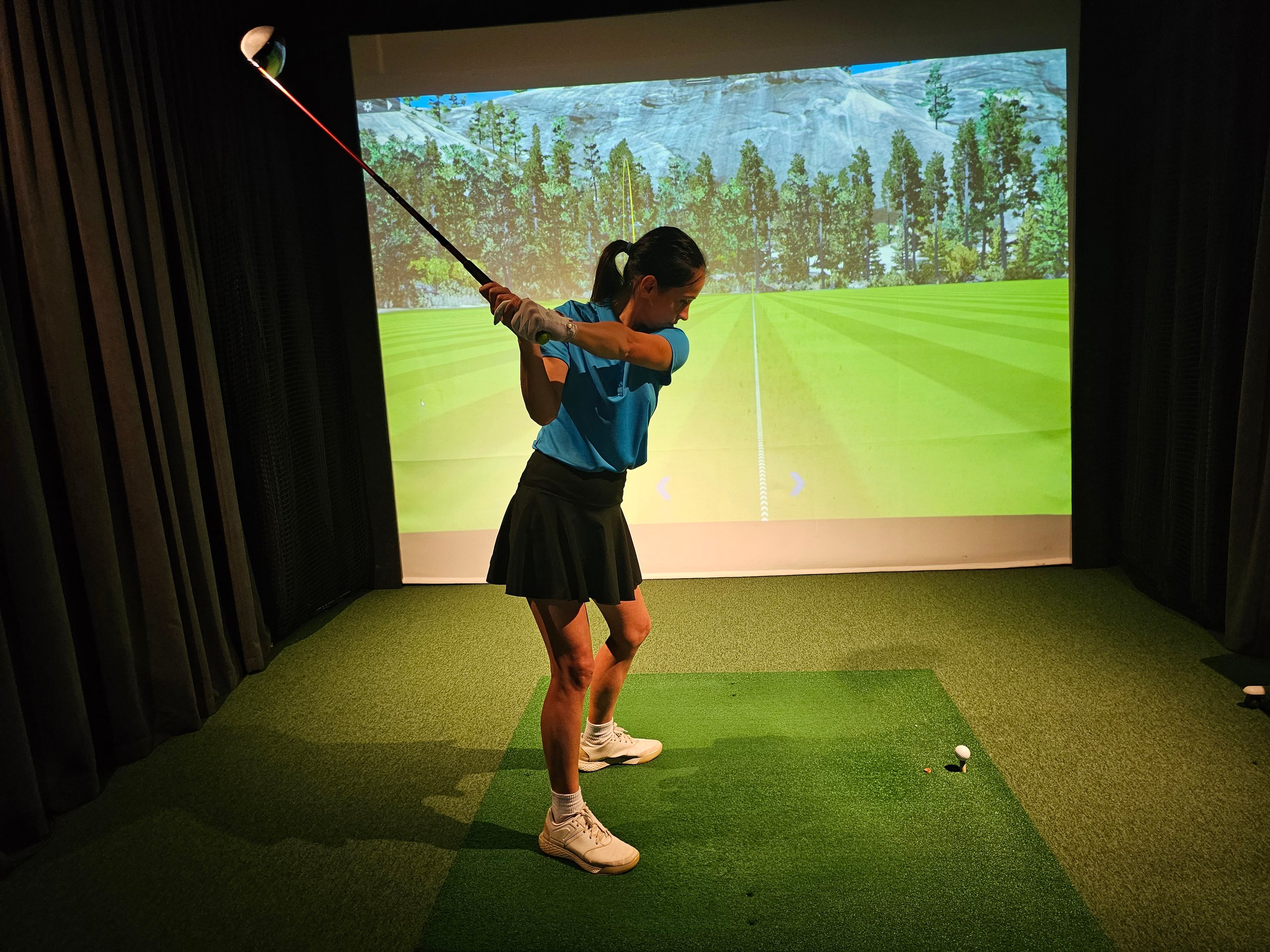Young golfer practicing indoors