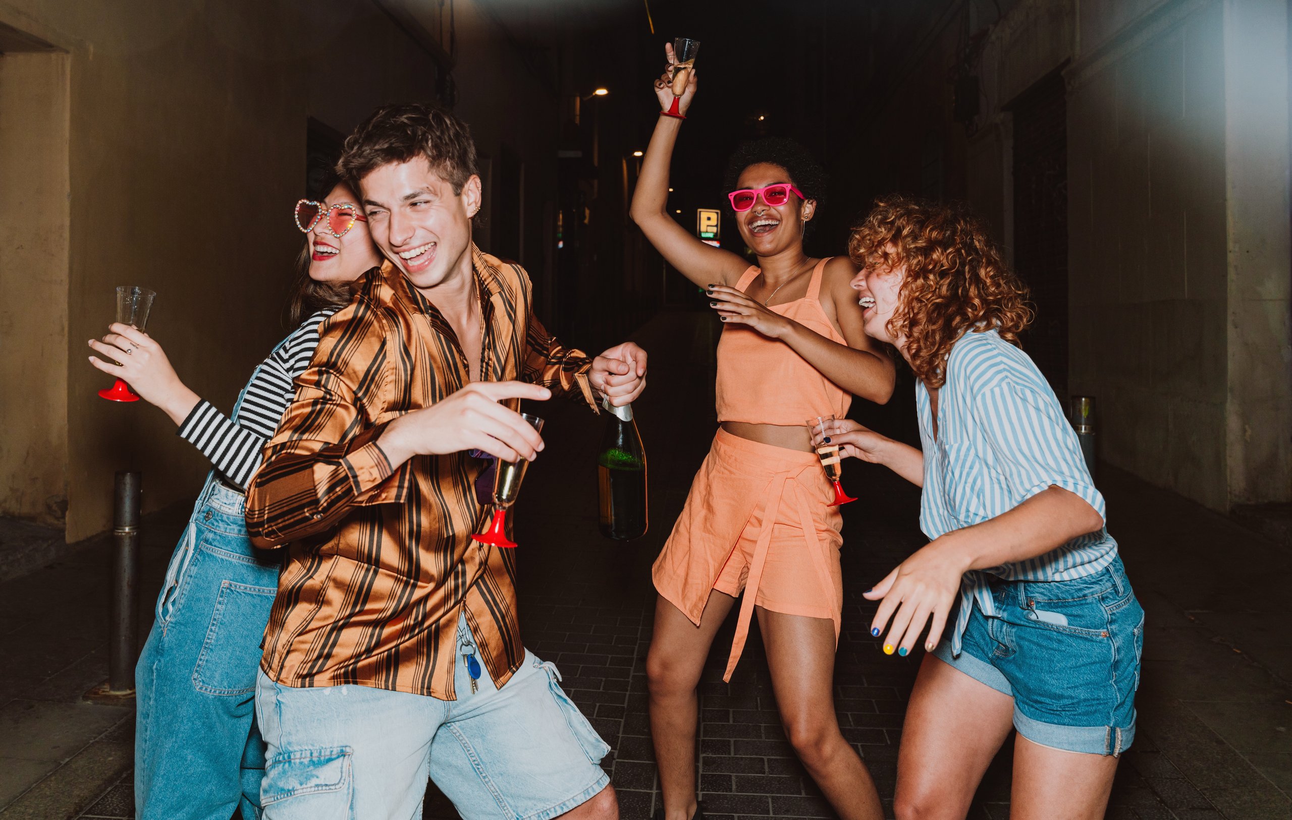 Friends going out in the evening and making party. Young people meeting outdoor in the weekend and celebrating together