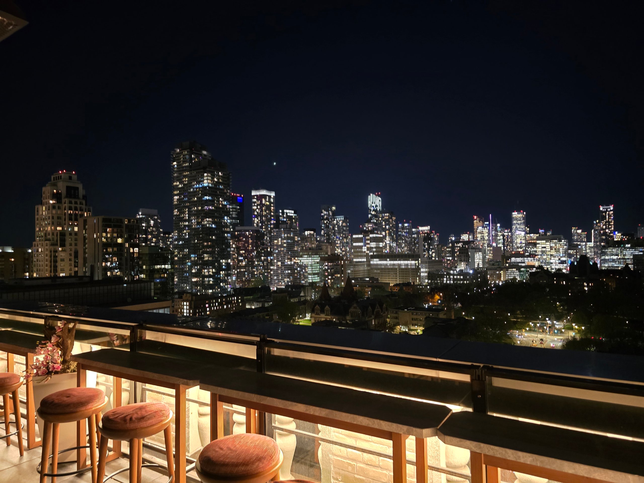 City skyline at night from rooftop bar