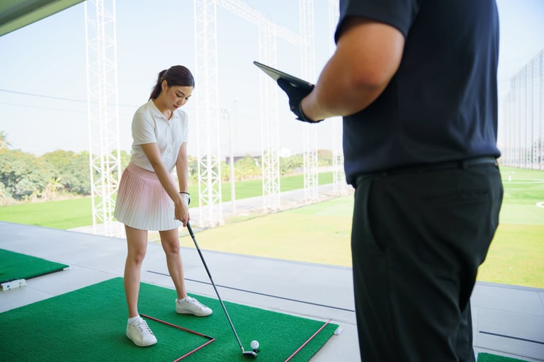 Golf instructor using tablet and launch monitor