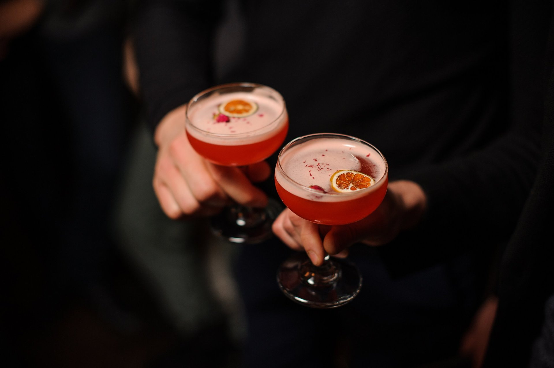 People holding cocktail glasses